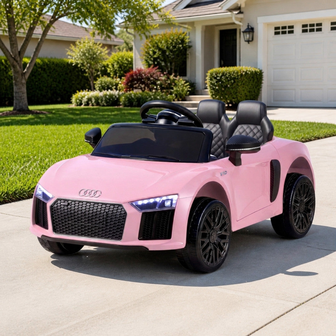 Pink Audi R8 kids electric ride on car on a driveway