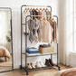 Clothing rack with clothes and shoes in a room with a bed and window.