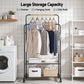 Clothing rack with shelves and hanging rods in a laundry room setting.