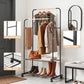 Clothing rack with clothes, shoes, and a mirror in a room setting.
