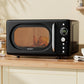 Black Devanti microwave oven on a kitchen counter with food inside