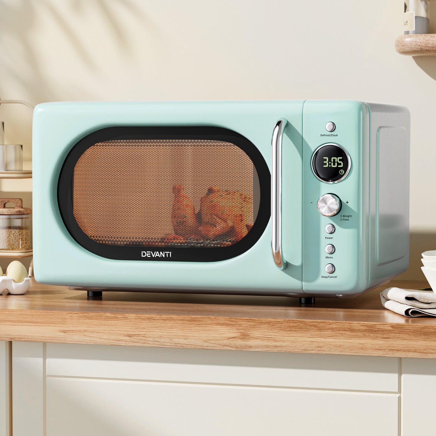 Mint green microwave oven on a kitchen counter with 'Devanti' branding.