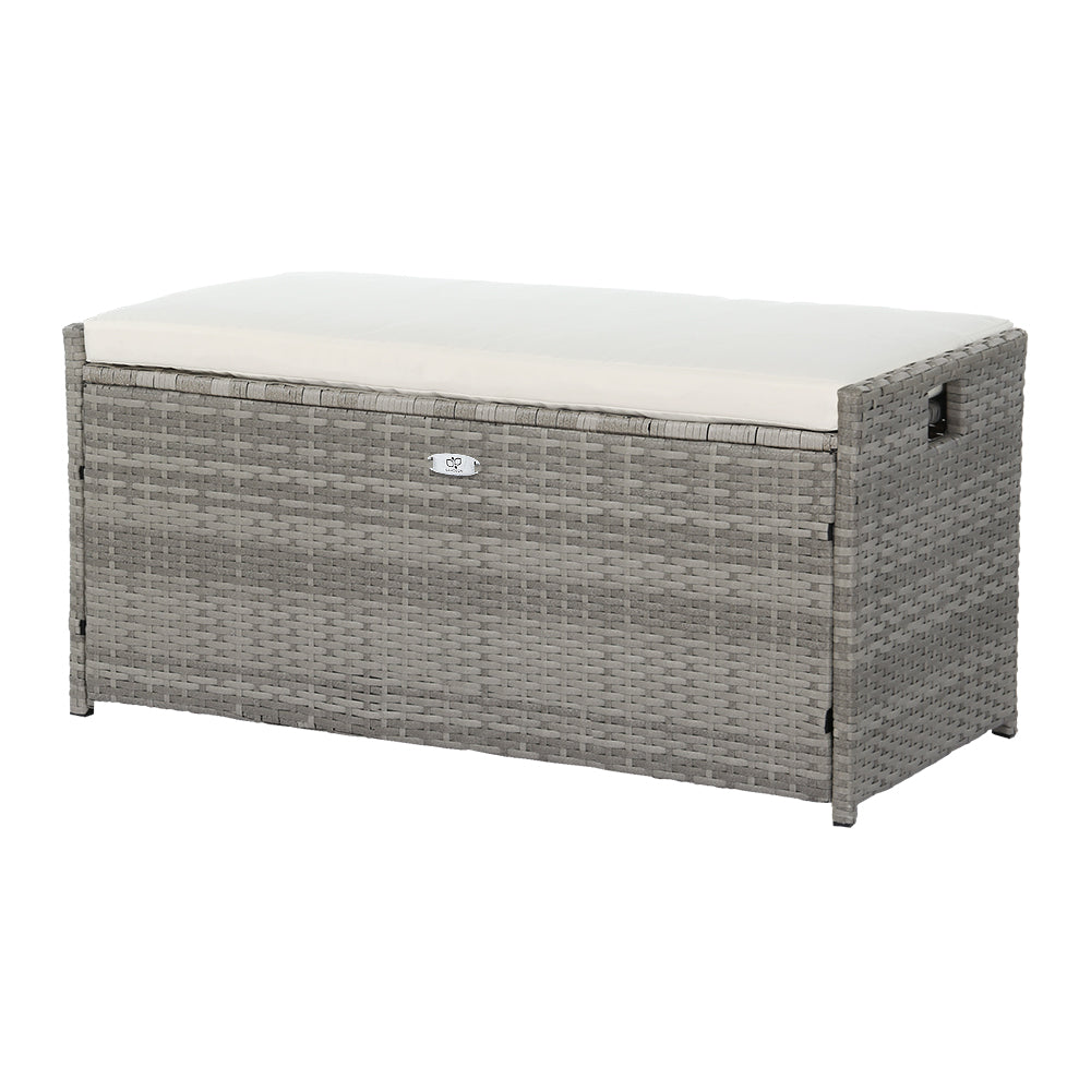 Gray wicker storage bench with a white cushion on a white background