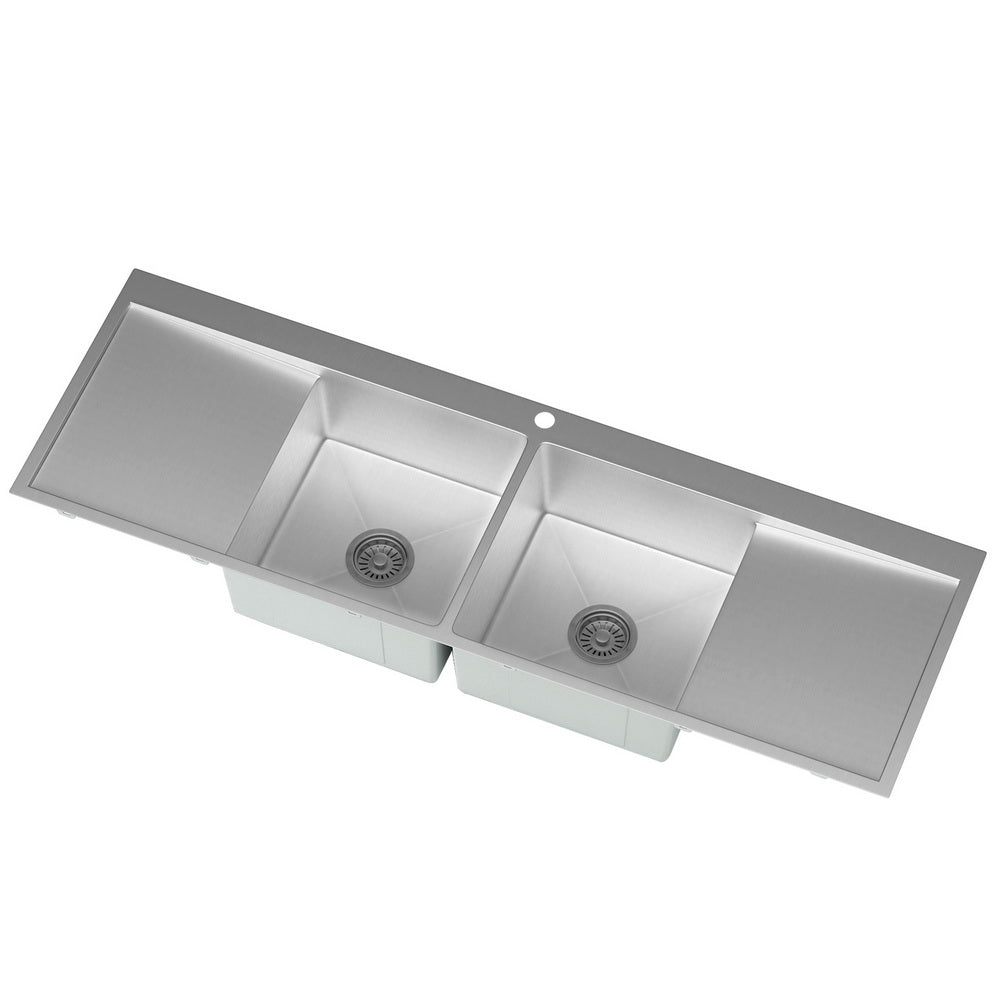 Stainless steel kitchen sink with a white background
