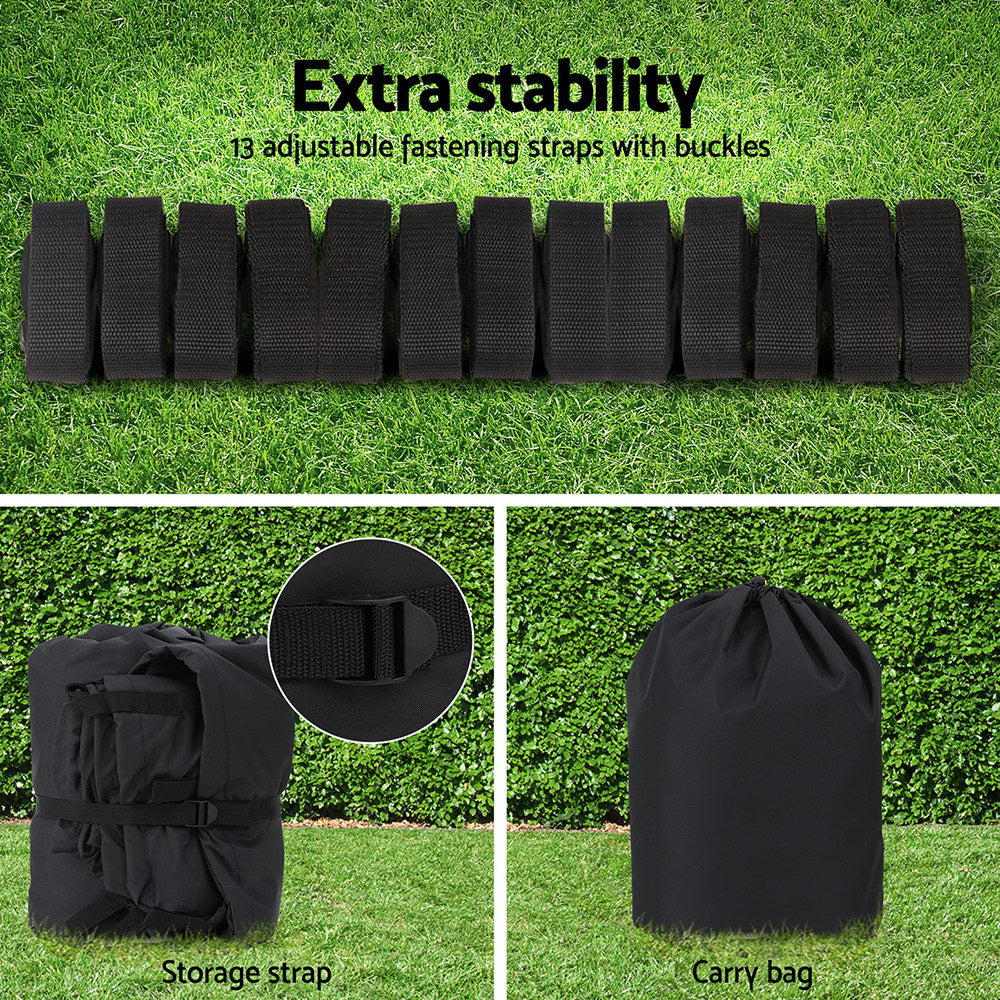 Black straps with buckles on grass, storage strap, and carry bag on a green background