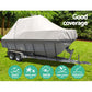 Boat covered with a protective cover on grass with 'Good Coverage' text and feature icons.