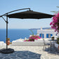 Blue patio umbrella with a black base on a white background