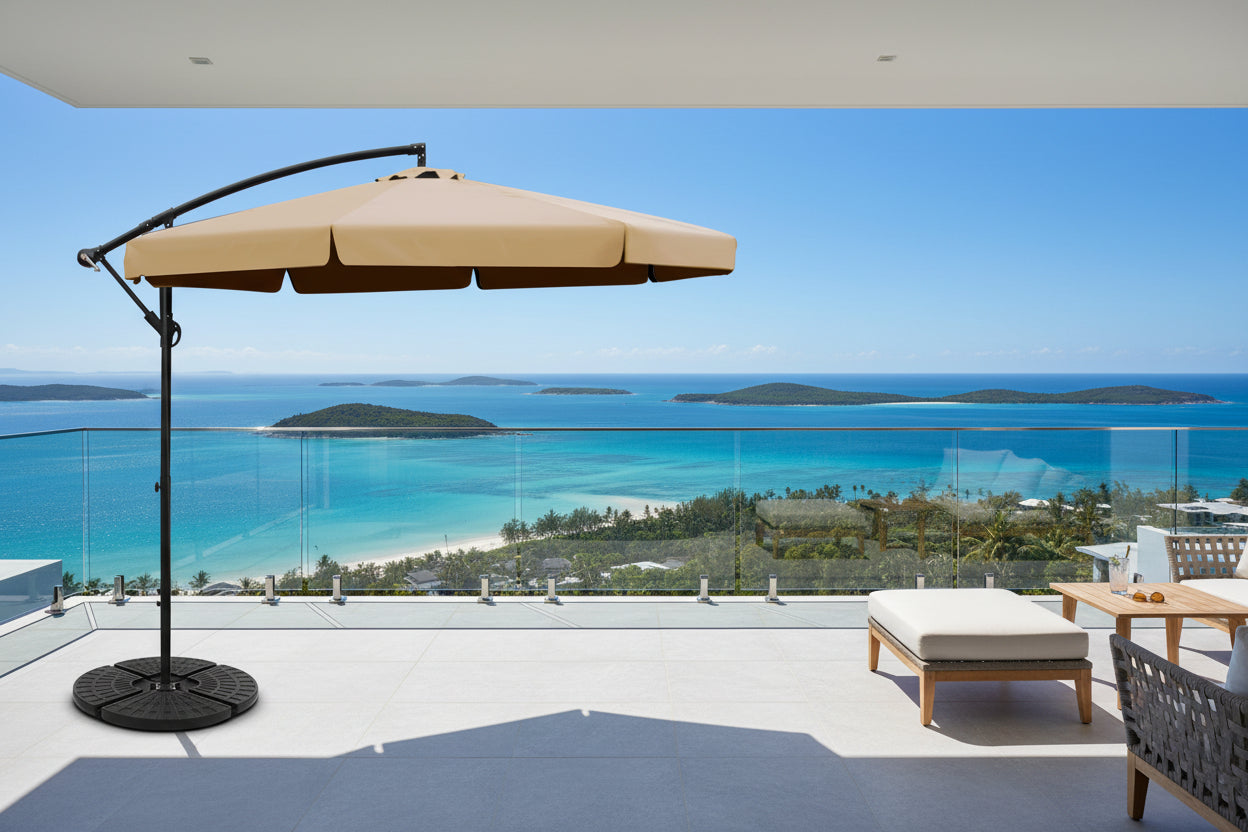 Beige patio umbrella with black stand on a white background