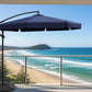 Black patio umbrella with a stand on a white background