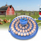 Egg incubator with digital display and egg turners with a farm in background