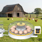 Egg incubator with eggs with a farim in the background